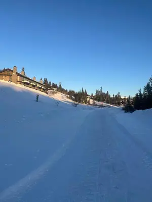 a snow covered road with a house in the background at Family Cabin From 1968 At Norefjell in Noresund