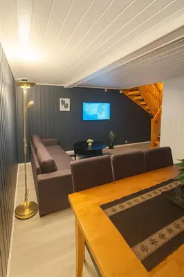 a living room with a couch and a table at Sentralt og elegant opphold nær alt in Lillehammer