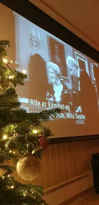a christmas tree in front of a projection screen at Cabin With Ski-Inout And Hot Tub In Fageråsen in Trysil