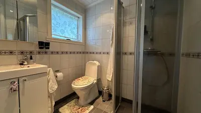 a bathroom with a toilet and a sink and a shower at Casa Hauge - Fjord View in Sandane