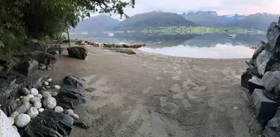 a view of a lake with rocks on the shore at Casa Hauge - Fjord View in Sandane