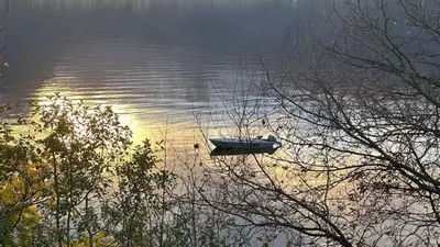 a boat in the middle of a body of water at Casa Hauge - Fjord View in Sandane