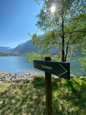 a sign that says nyssgment in front of a lake at Fjellperlen, Hardangervidda in Eidfjord