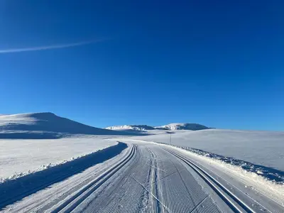 a road covered in snow in a snowy field at Fjellperlen, Hardangervidda in Eidfjord