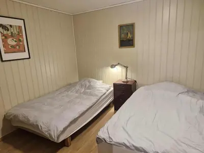 a bedroom with two beds and a lamp in it at Utsikten in Masfjorden
