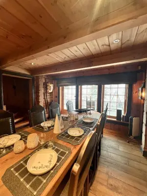 a dining room with a long table and chairs at Cabin in Kvamskogen in Kvam
