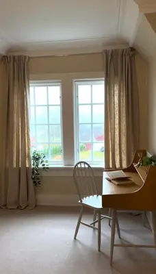 a desk and a chair in a room with a window at Historic villa with large garden in Stord