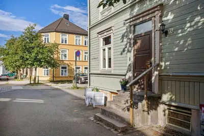 a house with two chairs sitting outside of it at Central 3-room apartment in Trondheim