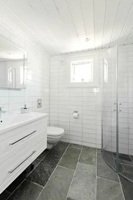a white bathroom with a toilet and a sink at Stranda Fjellgrend 3 bedrooms - 98B in Stranda