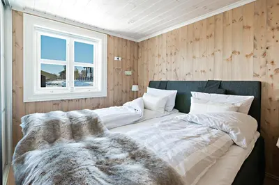 a large bed in a room with a window at Stranda Fjellgrend 3 bedrooms - 98B in Stranda