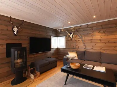 a living room with a couch and a flat screen tv at Stranda Fjellgrend 3 bedrooms - 98A in Stranda