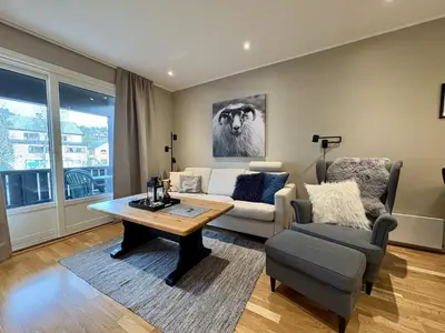 a living room with a couch and a table at Central apartment - walking distance to everything in Holo