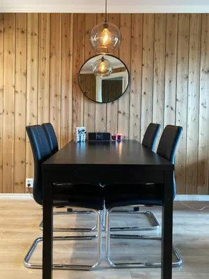 a black dining room table with chairs and a mirror at Apartment in Gol Skisenter in Gol
