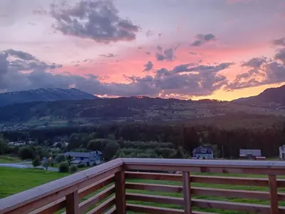 a sunset from the deck of a house at Spacious and luxurious house with stunning views in Vossevangen