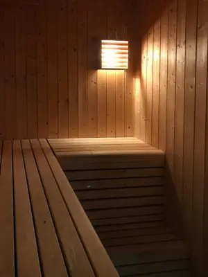 a wooden sauna with a light on the wall at Family Cabin With Panoramic Views In Aurdalsåsen in Aurdal