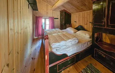 a bedroom with a bed in a wooden cabin at Stunning Home In Austbygda With Wifi in Austbygdi