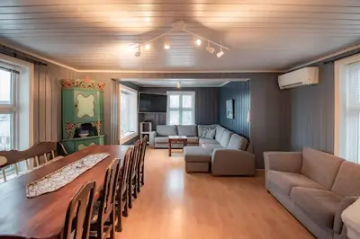 a living room with a long table and a couch at Sentralen in Trysil