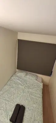 a bedroom with a bed with two slippers on it at Guesthouse centrum location in Lii