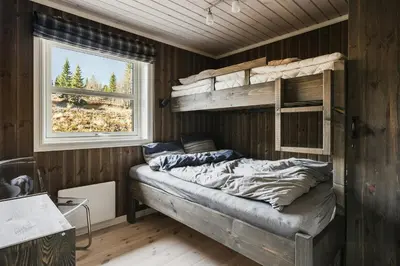 a bedroom with a bunk bed and a window at Mountain Cabin With Ski Inout In Trysil in Trysil