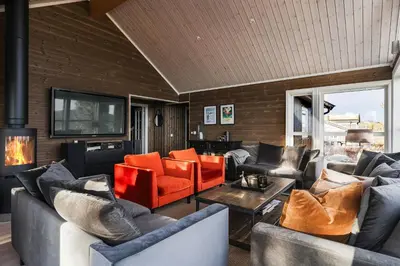 a living room with couches and a tv at Mountain Cabin With Ski Inout In Trysil in Trysil