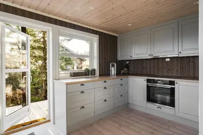 a kitchen with white cabinets and a window at Mountain Cabin With Ski Inout In Trysil in Trysil