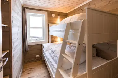 a bedroom with bunk beds in a tiny house at Stranda Fjellgrend 2 bedrooms and loft - 14B in Stranda