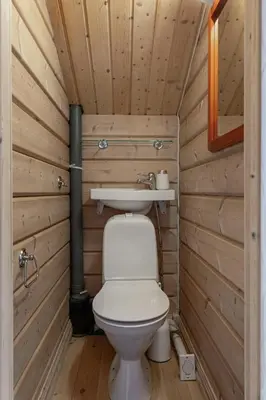a small bathroom with a toilet and a sink at Timber Cabin With Panoramic Views At Spåtind in Etnedal