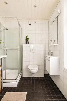a bathroom with a toilet and a shower and a sink at Modern 1BR in heart of old town in Bergen