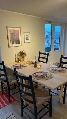 a dining room with a table with plates and chairs at 1 minute to the train station - Exclusive Penthouse! in Vossevangen