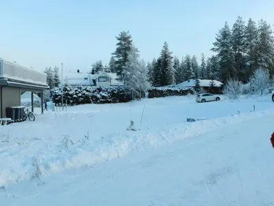 a street covered in snow next to a house at Trysil Central Villa in Trysil