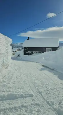 a building is covered in snow in front at Family Cabin Near Rallarvegen And Geilo in Ustaoset