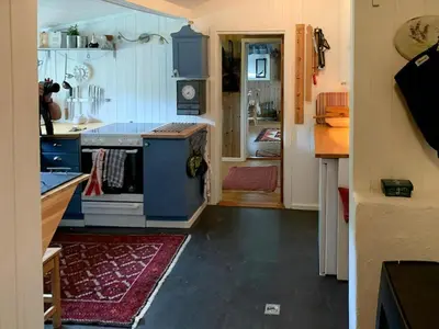 a kitchen with a blue stove and an open door at Family Cabin Near Rallarvegen And Geilo in Ustaoset