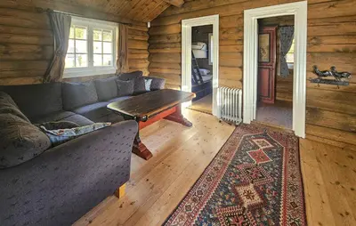 a living room with a couch in a log cabin at Cozy Home In Eggedal With Wifi in Eggedal