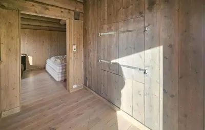 a room with wooden walls and a room with a bed at Cozy Home In Eggedal With Wifi in Eggedal