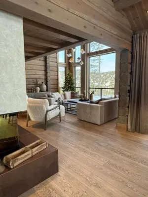 a living room filled with furniture and a large window at New exclusive cabin - panoramic view with ski in-out, Kvitfjell Varden in Ringebu