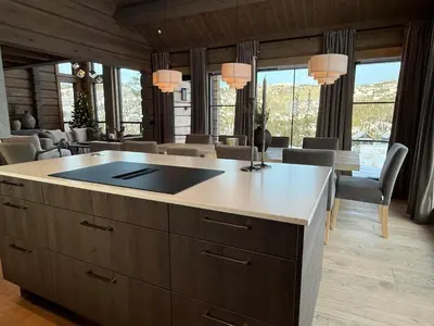 a kitchen with a large island in a living room at New exclusive cabin - panoramic view with ski in-out, Kvitfjell Varden in Ringebu
