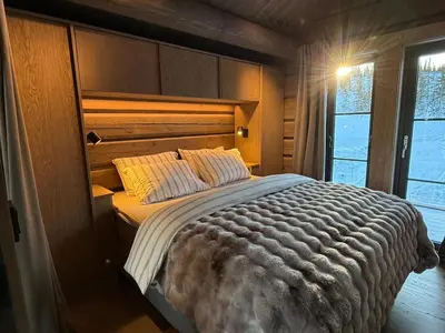 a bedroom with a large bed in a room at New exclusive cabin - panoramic view with ski in-out, Kvitfjell Varden in Ringebu