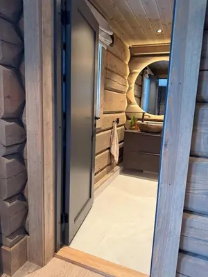 a door leading into a bathroom with wooden walls at New exclusive cabin - panoramic view with ski in-out, Kvitfjell Varden in Ringebu