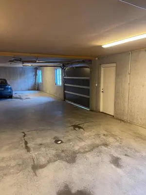 an empty garage with a car parked in it at Stranda Fjellgrend 3 bedrooms - 29C in Stranda