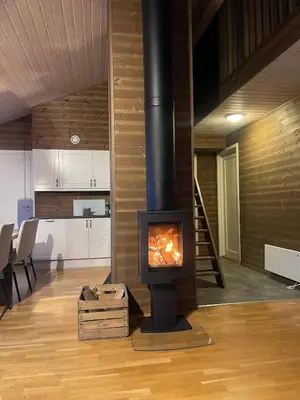 a fireplace in the middle of a living room at Stranda Fjellgrend 3 bedrooms - 29C in Stranda