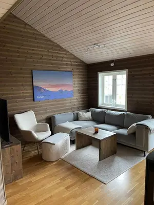 a living room with a couch and a table at Stranda Fjellgrend 3 bedrooms - 29C in Stranda