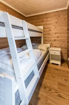 a bedroom with bunk beds in a log cabin at Stranda Fjellgrend 3 bedrooms and loft - 80D in Stranda