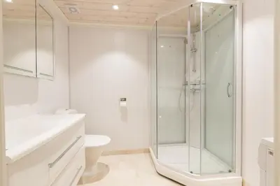 a white bathroom with a shower and a toilet at Stranda Fjellgrend 3 bedrooms and loft - 80D in Stranda