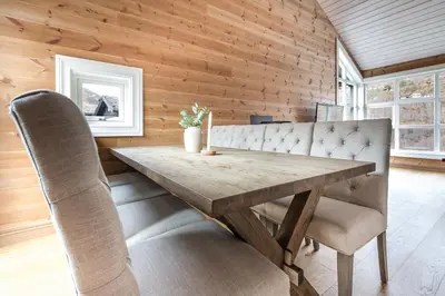a wooden dining room with a wooden table and chairs at Stranda Fjellgrend 3 bedrooms and loft - 80D in Stranda