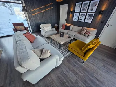 a living room with two couches and two chairs at Winter cabin with Jacuzzi in Trysil