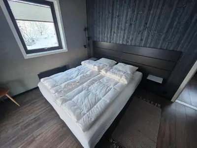a large bed in a bedroom with a window at Winter cabin with Jacuzzi in Trysil