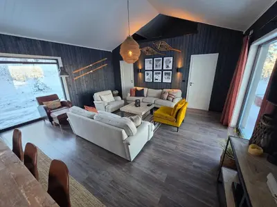 a living room with two couches and a table at Winter cabin with Jacuzzi in Trysil