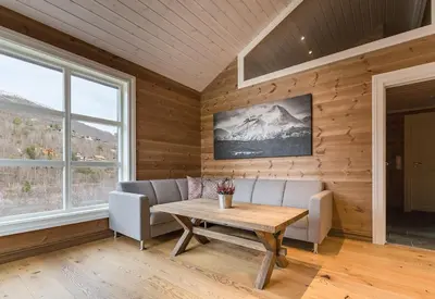 a living room with a table and a couch at Stranda Fjellgrend 3 bedrooms and loft - 80C in Stranda