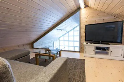 a living room with a large flat screen tv at Stranda Fjellgrend 2 bedrooms and loft - 24B in Stranda