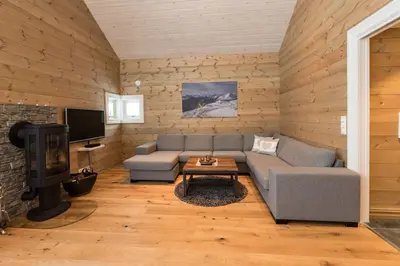 a living room with a couch and a tv at Stranda Fjellgrend 2 bedrooms and loft - 24B in Stranda